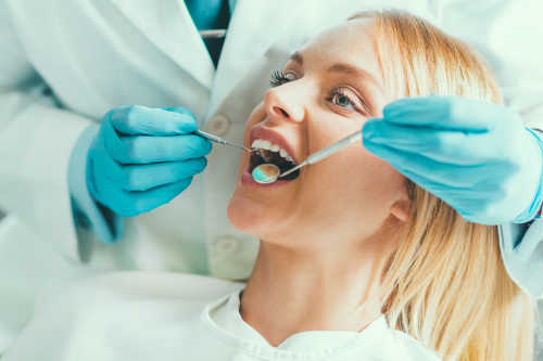 Patient having dental cleaning to protect tooth enamel.